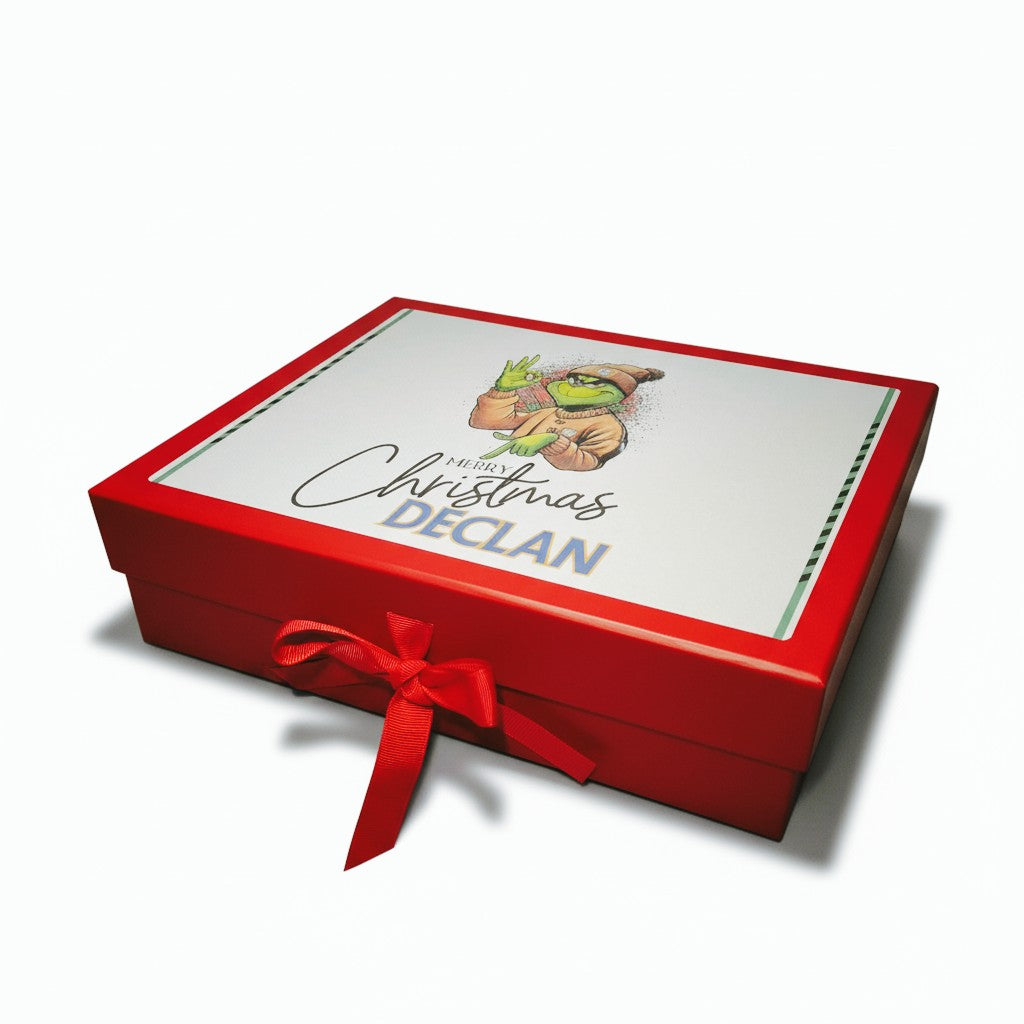 Red gift box with a white label featuring 'Merry Christmas Declan' and a red ribbon on a white background.