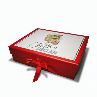 Red gift box with a white label featuring 'Merry Christmas Declan' and a red ribbon on a white background.