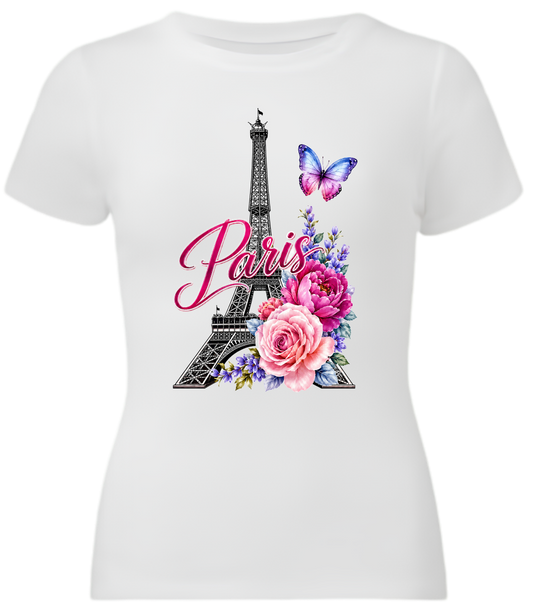White short-sleeve crewneck t-shirt featuring a Paris-themed graphic print with the Eiffel Tower, pink script 'Paris', pink and purple flowers, and a butterfly.