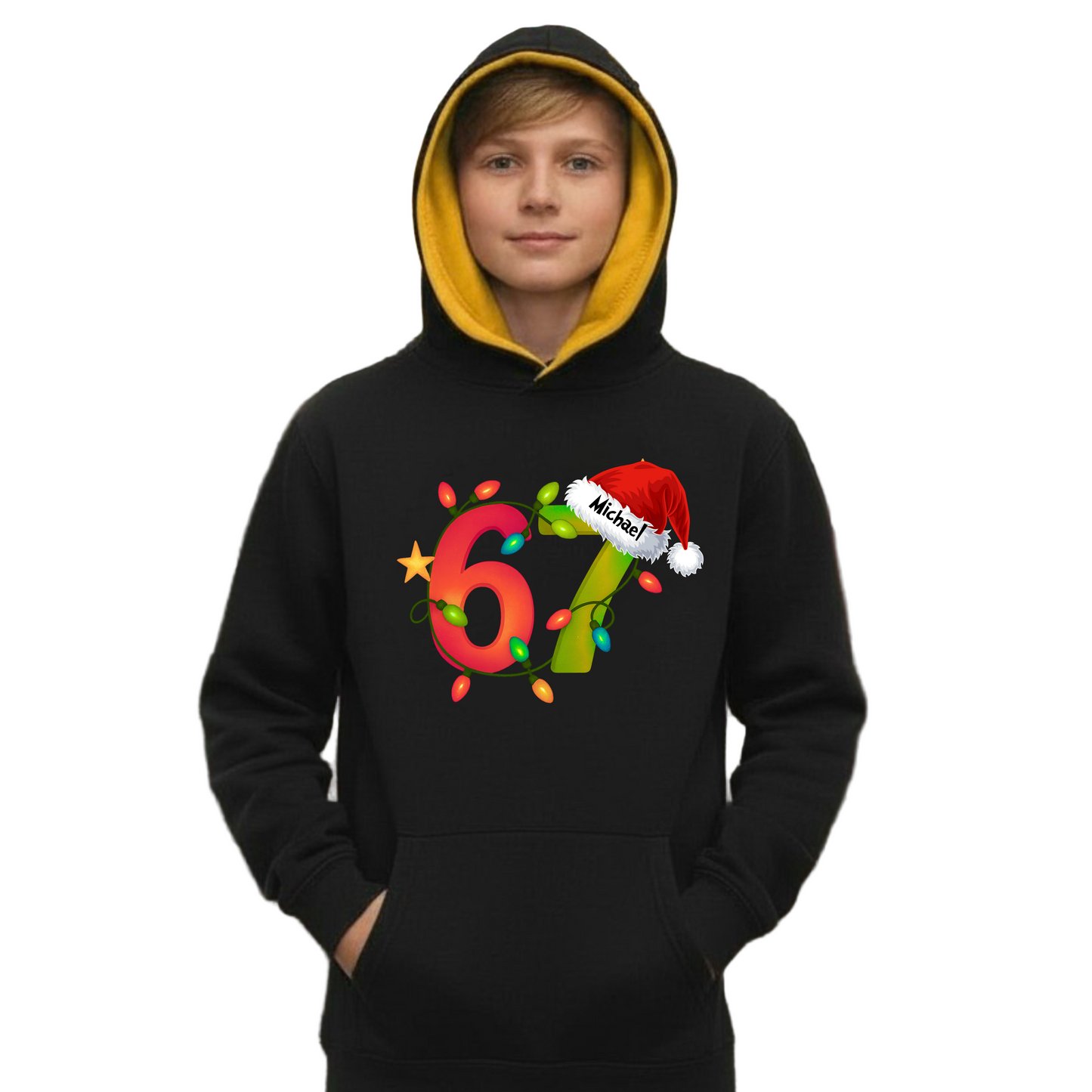Child wearing a black kids hoodie with a gold hood featuring a colourful 6 7 Christmas lights design and Santa hat, festive street background