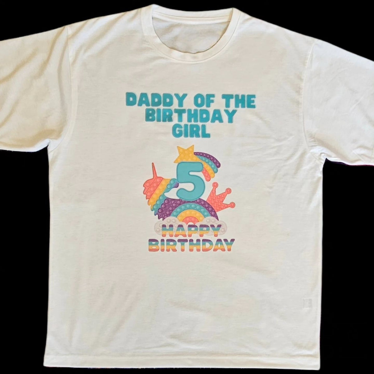 A white t-shirt with a colorful 'Pop It' design and text celebrating a birthday, featuring the number 5 and the phrase 'Daddy of the Birthday Girl'.