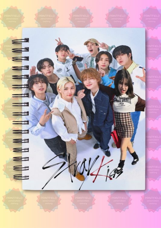 Notebook with a colorful design featuring a group of people on a pastel straykids group